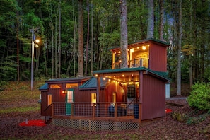 A cabin with a two-story structure, a deck, and a fenced area. - Beautiful Cabin with Fire Pit in Hayesville, North Carolina (Hayesville)