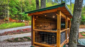 A wooden cabin with a sloped roof, a window with a metal grid, and a sign reading 'Free Spa.'