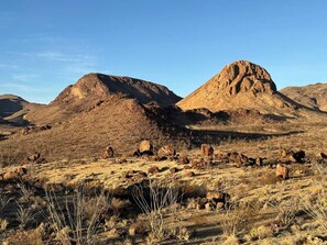 A desert landscape with rocky terrain and sparse vegetation.