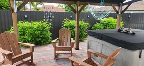 An outdoor patio with wooden chairs and a built-in bar. - Tropical Paradise | Boat Parking | Pet Friendly (Miami)