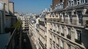 A row of historic European-style buildings with multiple stories, balconies, and classic architectural details. - CHAMPS ELYSEES APARTMENT (Paris)