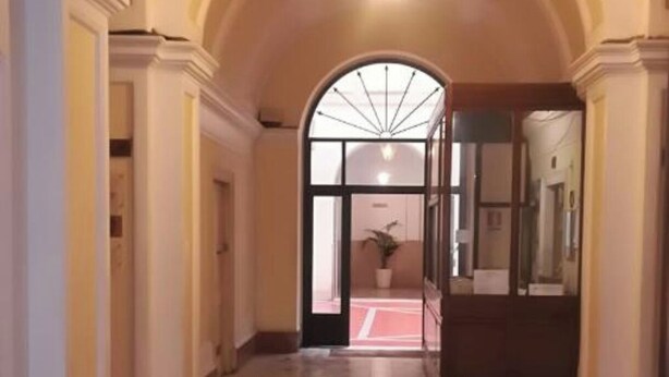 A hallway with a tiled floor, arched ceiling, and a light fixture. - Sixty one luxury room Apartment 100 sqm.,central, in prestigious area. (Roma)
