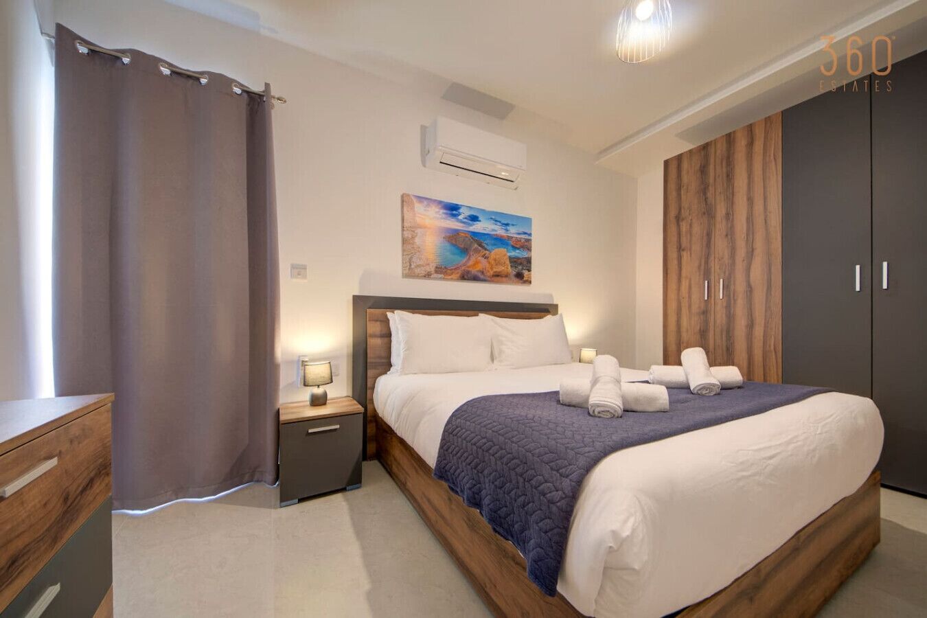 A modern bedroom with a large bed, a nightstand, a wooden wardrobe, and a painting on the wall.