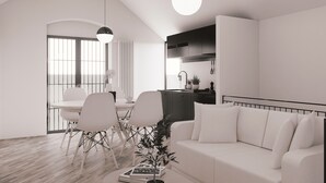 Un salon moderne avec un canapé blanc, un coin repas comprenant des chaises et une table, et un espace cuisine avec des placards et un plan de travail.