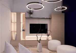 A modern living room with a TV, a white vase with branches, and circular ceiling lights. - La Villetta - Restyling in corso 2026 (Milano)