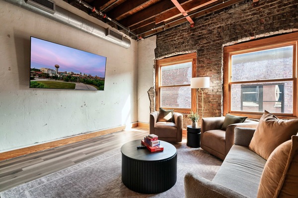 Urban charm with exposed brick, chic furniture, and vibrant sunset views await you!