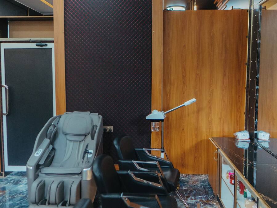Un cuarto de masajes con una camilla, una mesita y una lámpara.