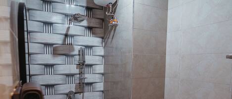 A modern bathroom with a shower, toilet, and sink.