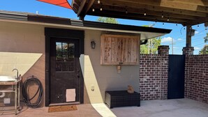 A covered outdoor area with a black door, a welcome mat, a metal sink, and a hose. - 
Dularge Fishing Hideaway!
Family and Pet friendly (Houma)