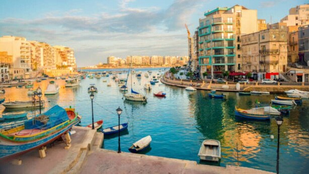 A marina with various boats docked, surrounded by buildings and a clear sky. - Modern City Home | Walk to Nightlife & Dining (St. Julian`s)