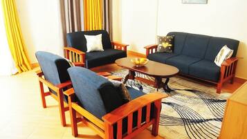 Family Apartment, City View | Living area | 32-inch Smart TV with digital channels