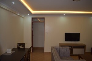 Deluxe Apartment, City View | Living area | 32-inch Smart TV with digital channels