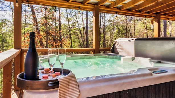 A hot tub with a wooden deck and a pergola overhead. - 8 Miles to Pigeon Forge, 15 Miles to Gatlinburg, Sleeps 8, Pool Table, Hot Tub, Game Room (Sevierville)