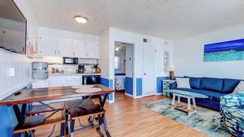 A compact living space with a kitchen, dining area, and seating area.