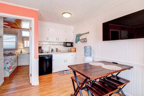 A compact kitchen with white cabinets, a microwave, and a water dispenser. - Inn on Turville Cottage, Sleeps 4, Waterfront (Berlin)