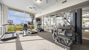 A gym with treadmills, elliptical machines, and weight equipment. - Gulf front condo w/ pools, gym, hot tub, sauna & beach path! (Orange Beach)