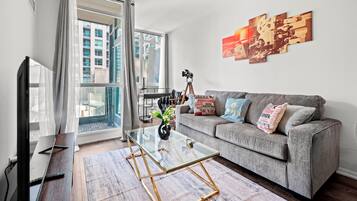 Deluxe Condo, 1 Bedroom, Balcony, City View | Living area | 43-inch flat-screen TV with satellite channels, Netflix