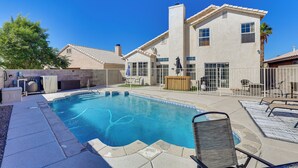 A residential swimming pool with a patio area, a covered hot tub, and a house with a tiled roof. - Pool, Games & Patio Bar! Epic Bullhead City Oasis (Bullhead City)
