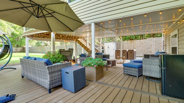A covered outdoor patio with wicker furniture, a fire pit, and string lights. - 1 Mi to White Bear Lake & Dtwn: Twin Cities Escape (White Bear Lake)