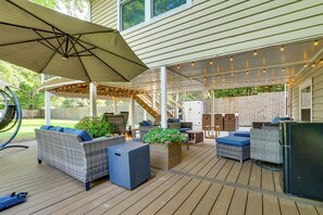 A covered outdoor patio with wicker furniture, a fire pit, and string lights. - 1 Mi to White Bear Lake & Dtwn: Twin Cities Escape (White Bear Lake)