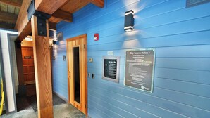 A hallway with blue walls, wooden beams, and a sign detailing dry sauna rules. - *NEW* Uncover Frisco's winning views w/resort-style amenities; total package! (Frisco)