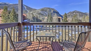A wooden deck with a table and chairs, overlooking a mountainous landscape. - *NEW* Uncover Frisco's winning views w/resort-style amenities; total package! (Frisco)