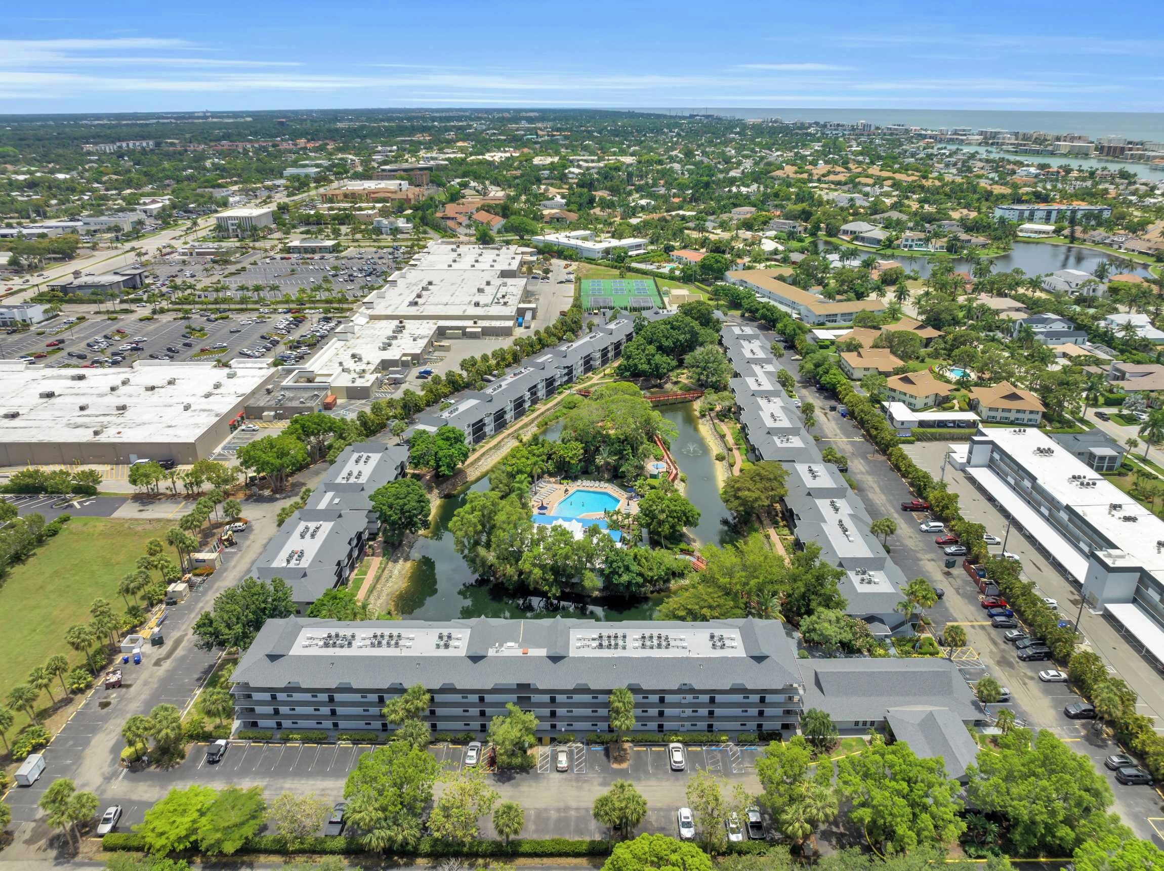 A multi-story parking structure with a central courtyard featuring a swimming pool.