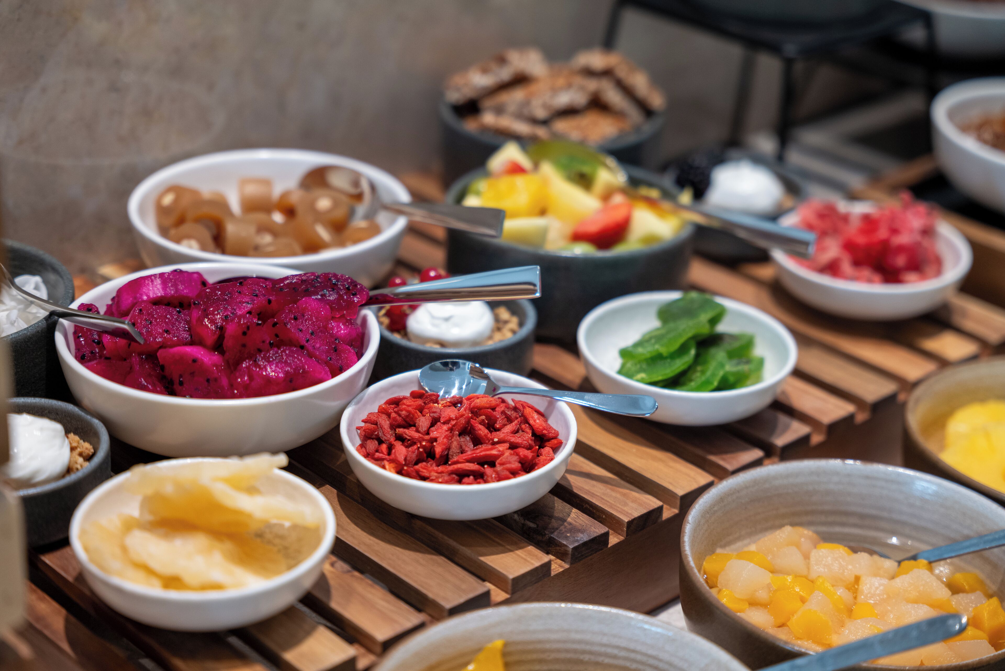 A variety of food items arranged on a wooden table.