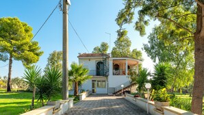 A two-story house with a balcony, a staircase, and a paved driveway leading to the entrance. - Villa 'Degli Ulivi' with Private Terrace and Air Conditioning (Manduria(c.da Scorcora))