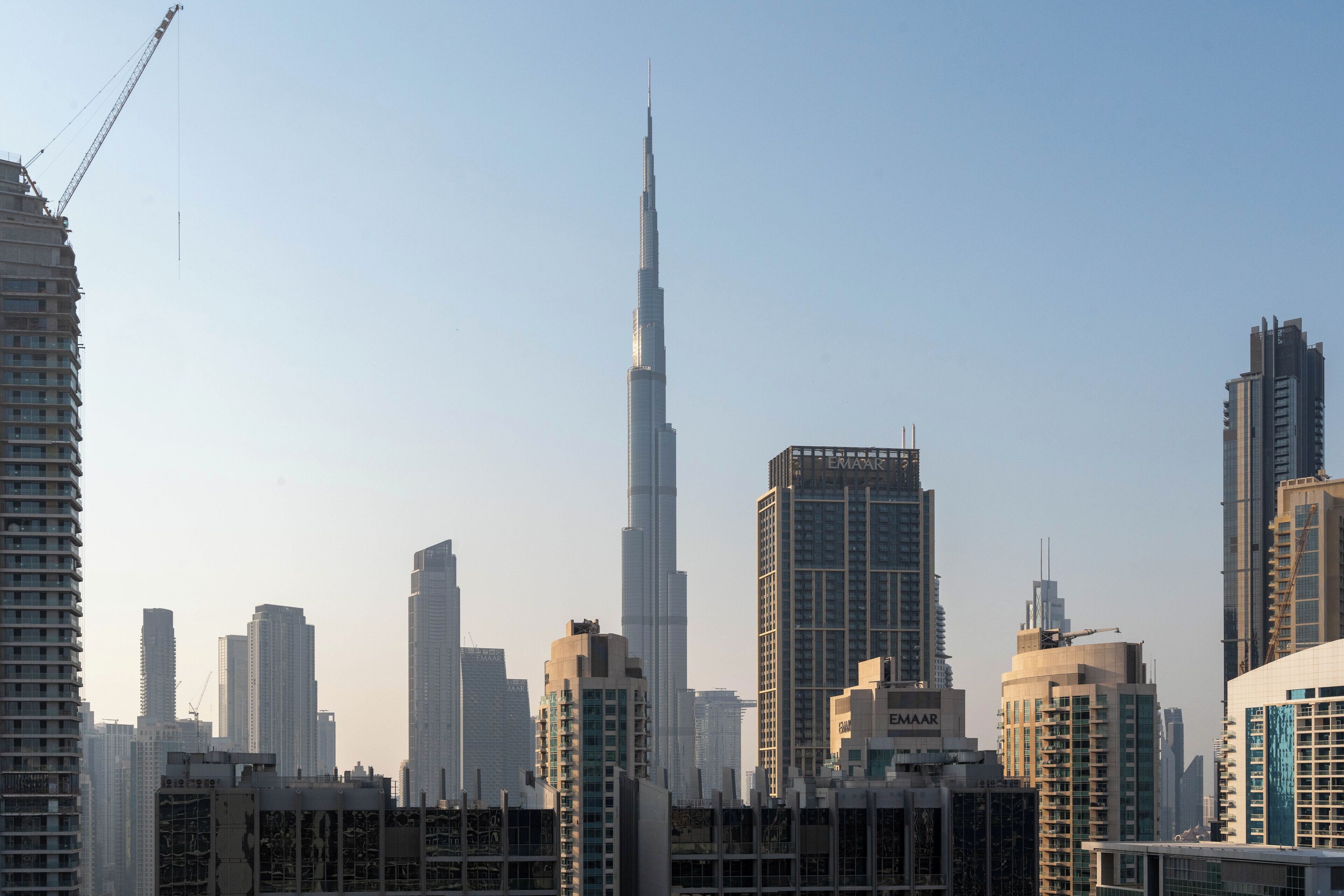 A cityscape with a prominent skyscraper, likely a hotel, featuring multiple floors and a modern architectural design.