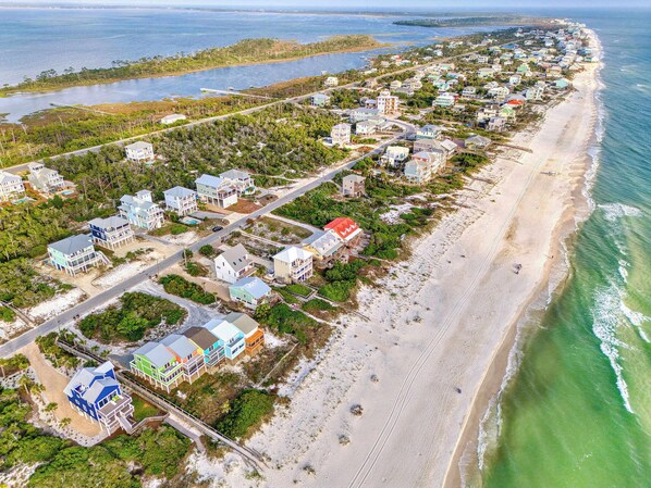 An aerial view of a coastal residential area with houses, roads, and a beach. - NEW- 3 bedroom, Private Pool North Cape (Port St. Joe)