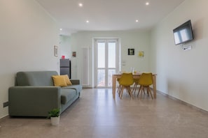 Apartment, 1 Bedroom | Living area | 30-inch TV with satellite channels