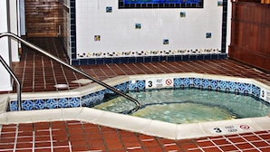 An indoor swimming pool with a tiled edge, a handrail, and a '3 feet deep' sign. - Crafts Inn, Hotel Suite with pool and hot tub. (Wilmington)