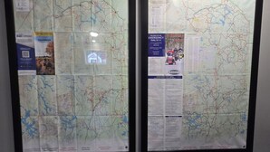 Two framed maps of ATV trails with a map legend, emergency contact information, and a list of Snowmobile Club members. - Charming 3-bedroom house in Presque Isle (Presque Isle)