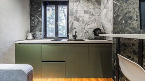 A compact kitchen with a window, a sink, and a countertop. - GOA Apartment 2 by Kondo Stays (Tiranë)