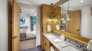 A modern bathroom with a wooden vanity, dual sinks, and a large mirror. - Modern 2 bedroom 2 bathroom Ski In&Ski Out 07 (Snowmass Village)