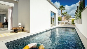 A swimming pool with a lounge area, a lamp, and a view of the surrounding buildings. - New and Luxurious Villa Los Olivos  (Adeje)