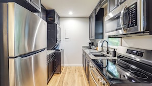 A modern kitchen with stainless steel appliances, a built-in oven, and a microwave. - Chic Cabin! Epic Views of Grandfather Mountain (Blowing Rock)