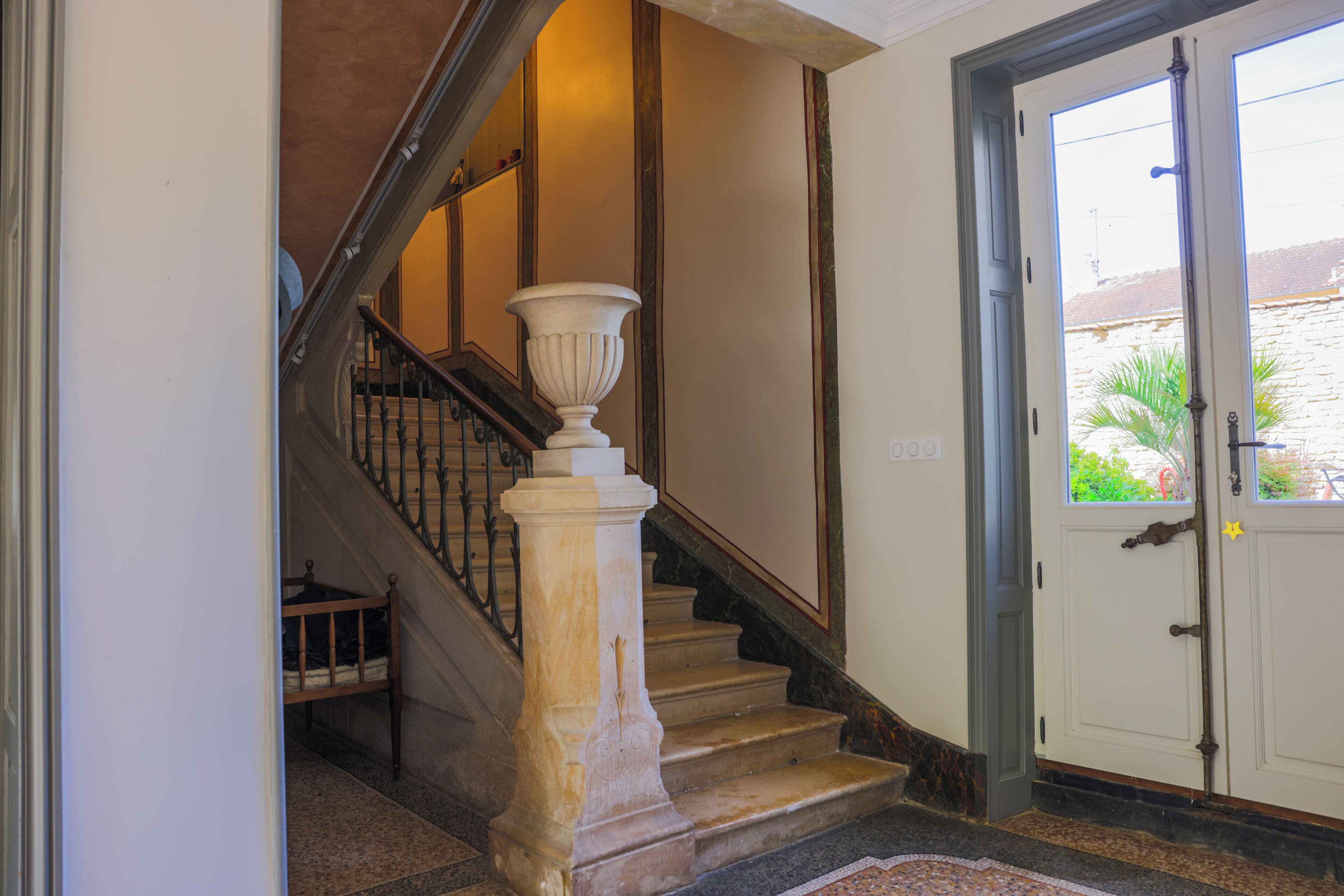 A staircase with a white balustrade and a white door with a window.