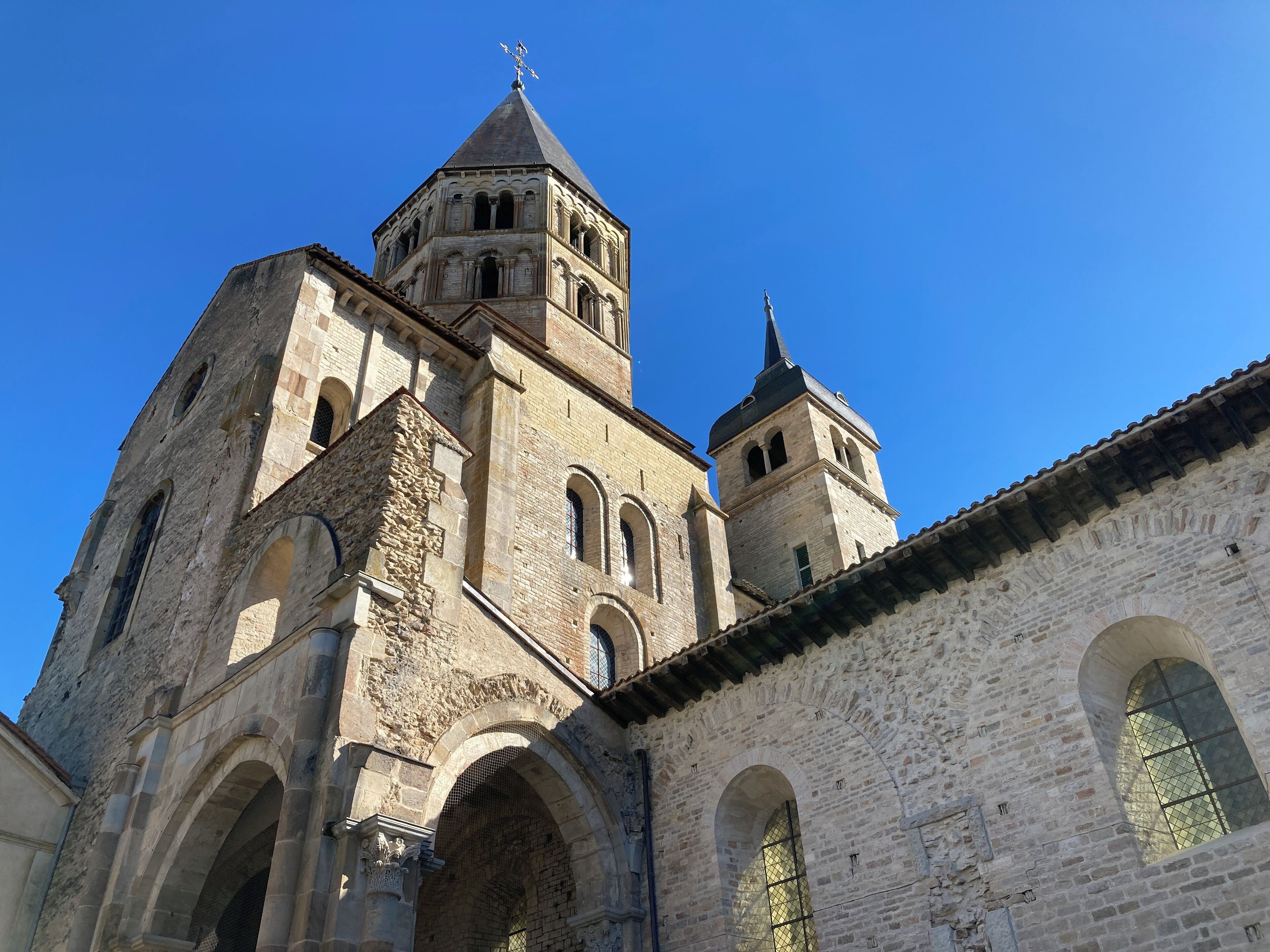 A historic stone building with multiple arches and a prominent bell tower.
