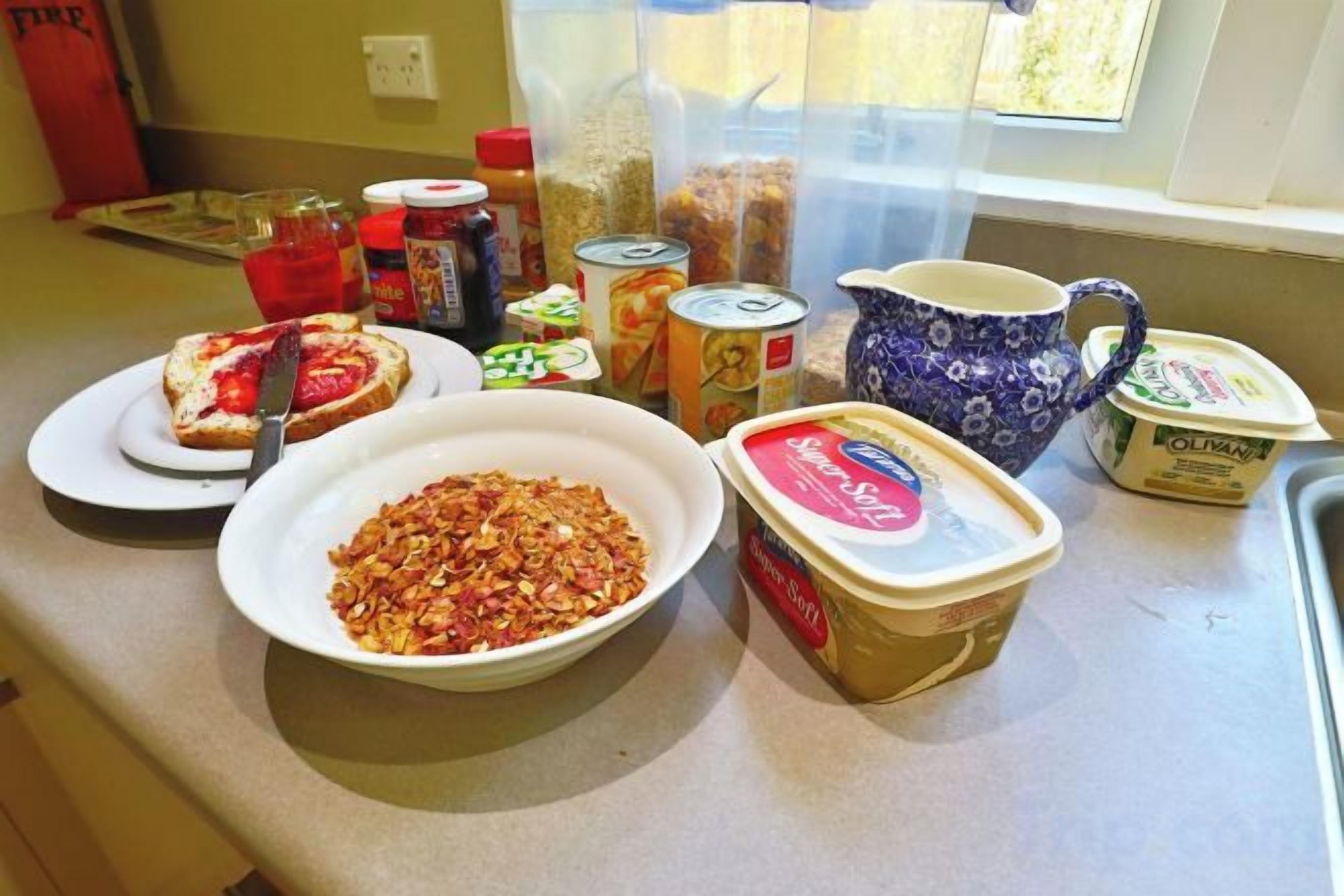 A kitchen counter with various food items and containers.