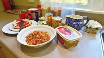 A kitchen counter with various food items and containers.