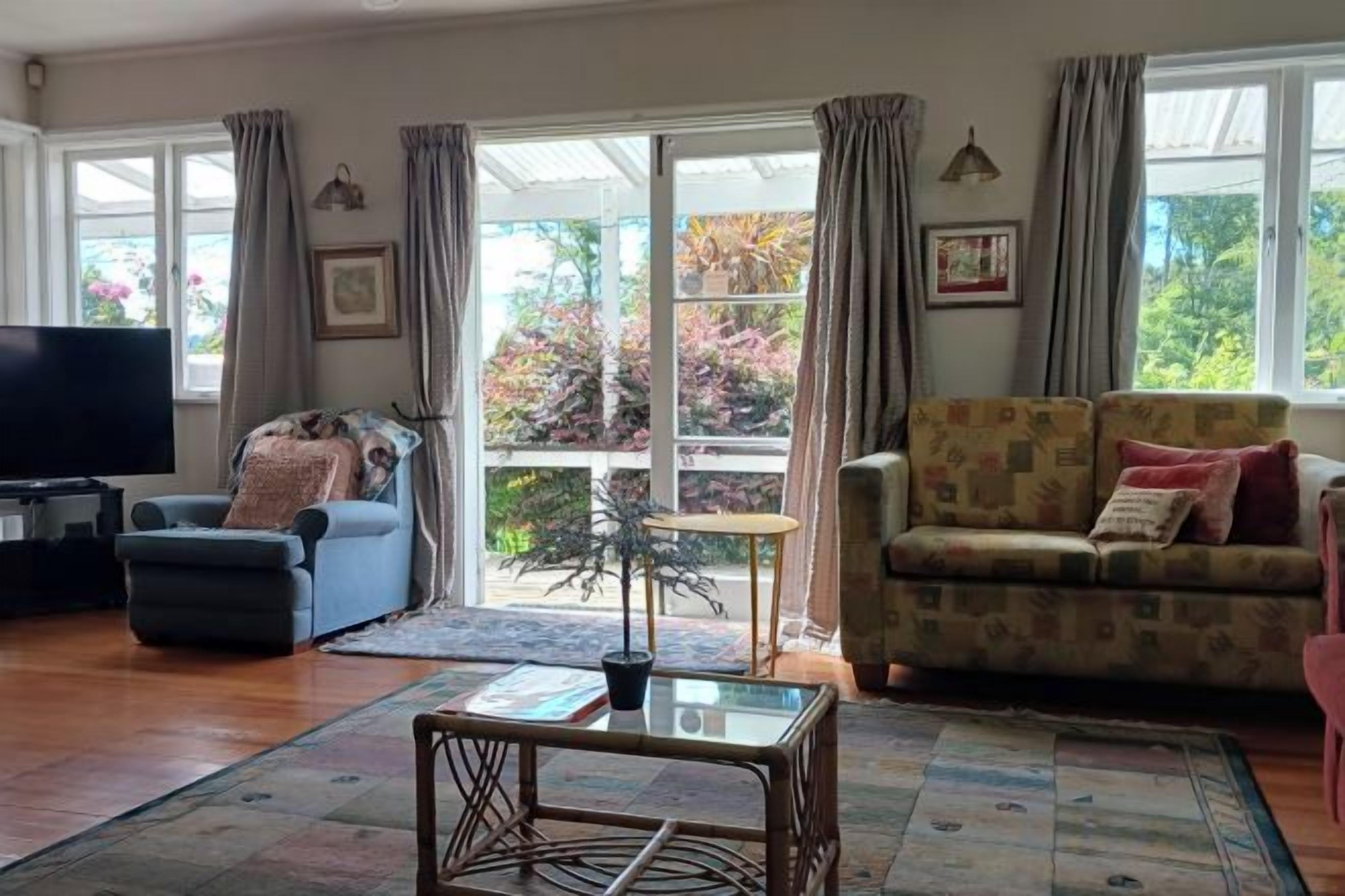 A living room with a sofa, armchair, and a coffee table.