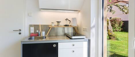 Fridge, stovetop, electric kettle, cookware/dishes/utensils