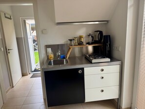 Fridge, stovetop, electric kettle, cookware/dishes/utensils