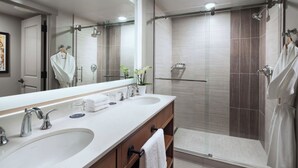A modern bathroom with dual sinks, a large mirror, and a walk-in shower. - Charming 2-bedroom Ski-in, Ski-out resort in lovely Steamboat Springs (Steamboat Springs)