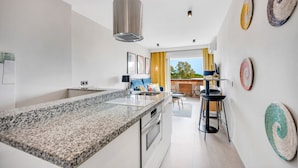 A modern kitchen with granite countertops, stainless steel appliances, and a large island. - Apartment 'Ocean View Dunas De Artola' with Sea View, Wi-Fi and Air Conditioning (Marbella)