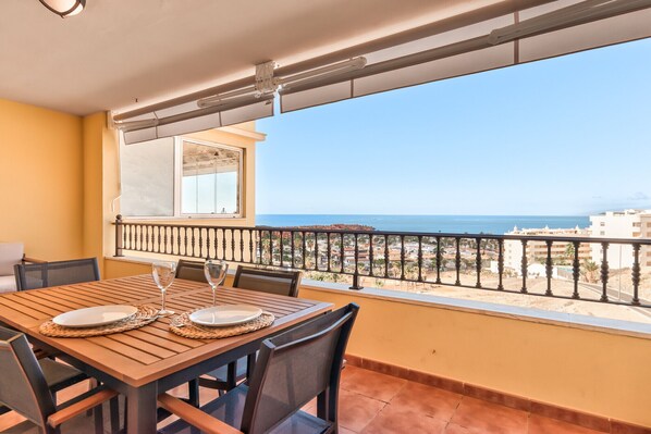 A balcony with a table set for two, overlooking a coastal view. - Laderas - FRONT SEA VIEW (Arona)