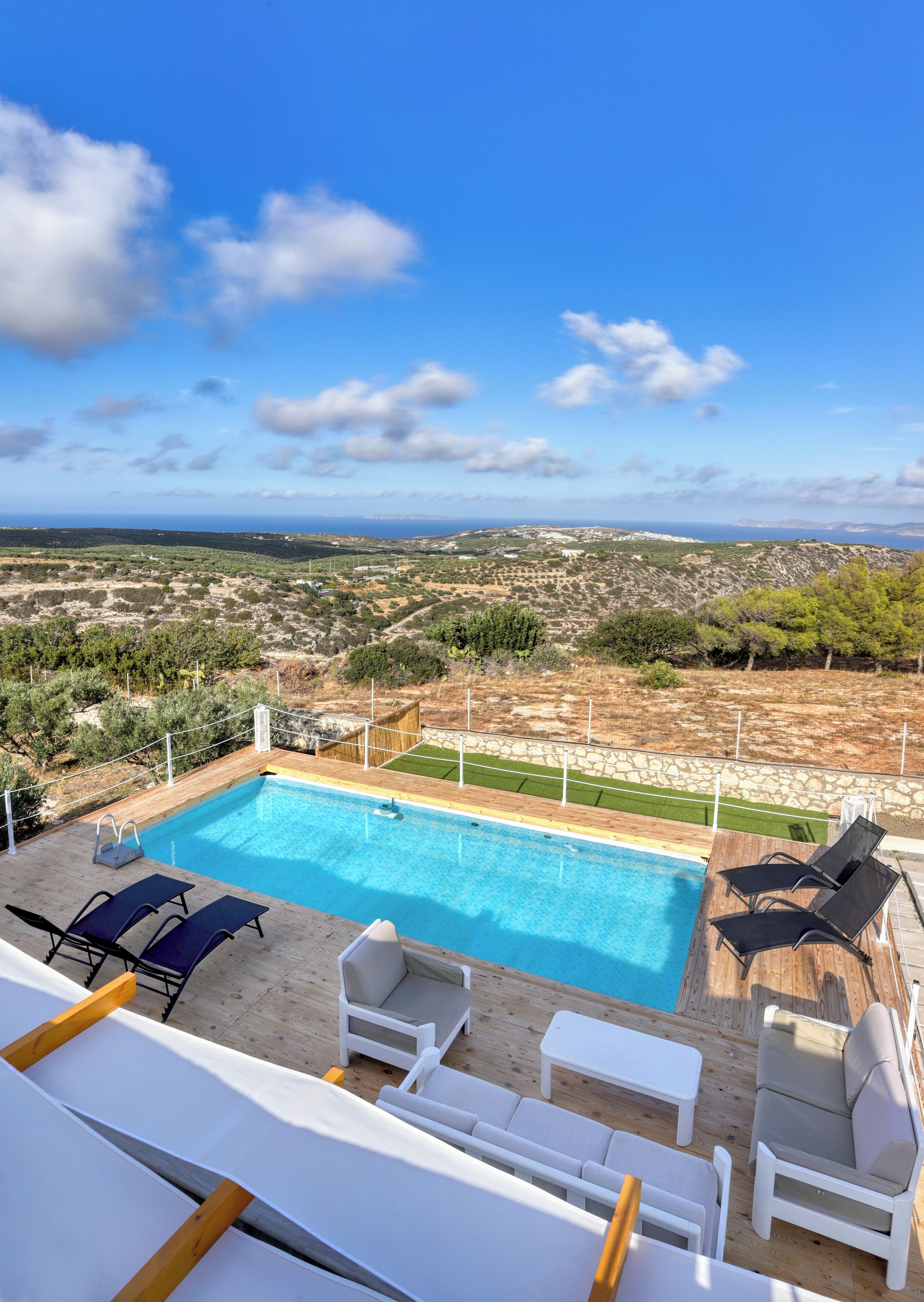 Outdoor space with spectacular views,  swimming pool, sun beds and sitting areas