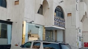 A building with a sign for 'SAVANETALMANA SERVICES INDUSTRIES'. - City Luxury Serviced Apartments (Madinah)